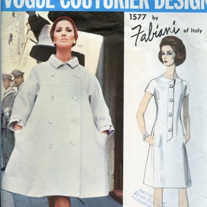May include: Vintage Vogue Couturier Design pattern featuring a woman in a light-colored double-breasted coat and a drawing of a white dress with buttons. The pattern is by Fabiani of Italy, design number 1577.