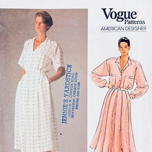 May include: Vogue Patterns American Designer sewing pattern 1525 featuring two dress designs. One dress is white with a small square pattern, the other is a pink button-up dress. The Calvin Klein logo is at the bottom.