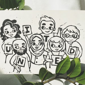 May include: A black and white linocut print depicting a diverse group of cartoon figures holding letters to spell "UNITED". The artwork has a handmade feel, with visible textures and a simple, bold style. Green leaves are in the foreground.