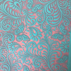 May include: Teal blue floral pattern on a pink background. The pattern features stylized butterflies and swirling vines.