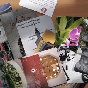 May include: A collection of cards with various images and text. The cards include a black and white image of a statue, a close-up of a pink orchid, a card with the text "the break I forth earth from wet green repeating pushing", and a card with the text "bloom then in perfection".