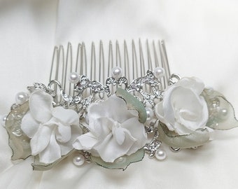 Bridal hair comb with white flowers and moss green leaves made with recycled fabric. Sustainable and different hair piece one of a kind.