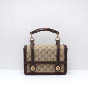 Gucci black leather lunchbox purse w bamboo handle & stripe