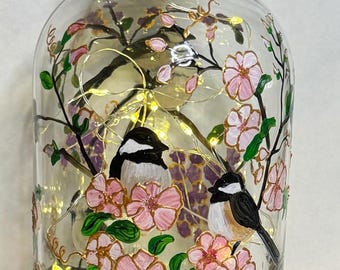 Beautiful hand painted bottle with fairy lights, chickadees and hand painted with cherry blossoms and gold outline, Adirondack Chickadees