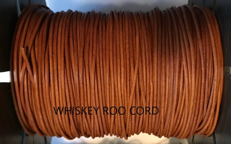 May include: A spool of brown leather cord labeled "WHISKEY ROO CORD".