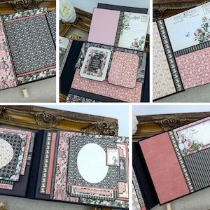 Op de afbeelding: Een zwart scrapbook met roze en zwart gepatroneerd papier, versierd met verschillende versieringen, waaronder bloemen, linten en kant. Het scrapbook is open om een pagina te onthullen met een cirkelvormig frame en een decoratieve rand.