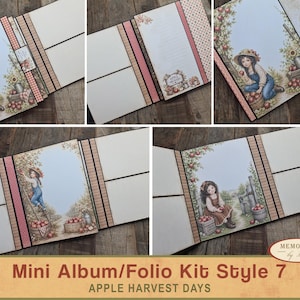 Puede incluir: Un kit de mini álbum tipo folio de varias páginas con temática de cosecha de manzanas. Las páginas incluyen cartulina color crema, bordes negros y detalles en papel estampado. Las ilustraciones muestran a un niño recogiendo manzanas.