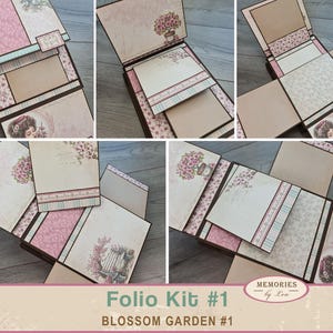 May include: A multi-panel scrapbook folio kit titled Blossom Garden #1, featuring various folding sections, pockets, and flaps decorated with floral patterns, pink and cream paper, and vintage-style illustrations of people and potted flowers.