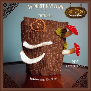 May include: A brown felt tree stump with a heart-shaped applique and mushrooms. The stump is 10 inches by 9 inches. The text "A4 PRINT PATTERN & TUTORIAL" and "LADY CLAIR of INKBLOT LANE" is visible in the image. The text "PDF PATTERN ONLY" is also visible.