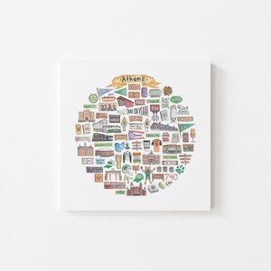 May include: A white square canvas print featuring a circular illustration of Athens, Ohio landmarks and icons. The design includes buildings, flags, and text, with the word "Athens" at the top.