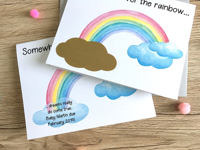 May include: A white card with a rainbow and clouds painted on it. The text "...dreams really do come true. Baby Martin due February 20191" is written on the card.