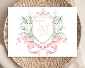 May include: A watercolor illustration of a crest with the initials "T.M." in pink, surrounded by green foliage and a pink ribbon bow.