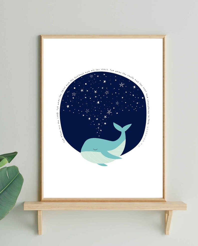 May include: A framed art print featuring a whimsical illustration of a blue whale with a starry night sky emanating from its blowhole. The whale is set against a white background, with a wooden frame. The artwork has a minimalist style.