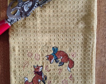 Foxes playing embroidered waffle weave tea towel
