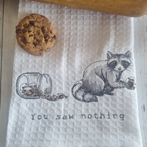 Waffle weave tea towel embroidered with a cute raccoon