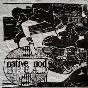 May include: Black and white graphic design of a person holding a round object with the text "native mod BREAD" on it.