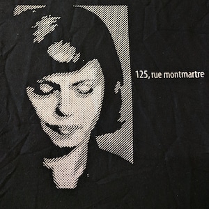 May include: Black and white graphic print of a woman's face with the text "125, rue montmartre" printed below the image.