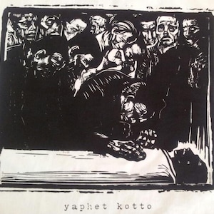May include: A black and white woodcut print showing a group of people gathered around a figure lying on a table. The print is titled "yaphet kotto".