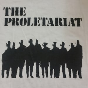 May include: White t-shirt with black text that reads "THE PROLETARIAT" and a silhouette of a group of people.