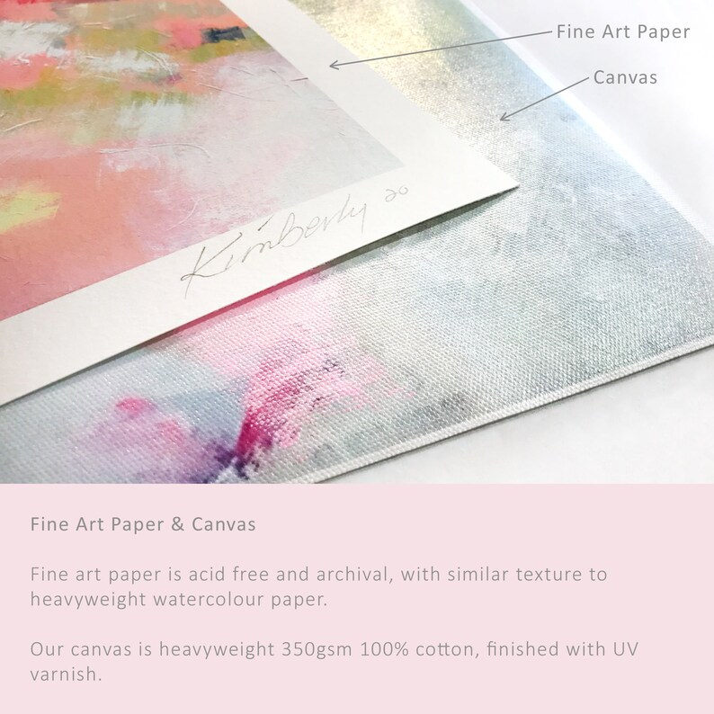 May include: Close-up of a white fine art paper print with a pink and blue abstract painting. The print is mounted on a white canvas with a textured surface. The text "Kimberly so" is handwritten in black ink on the paper.