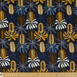 May include: A dark navy blue fabric featuring a repeating pattern of stylized banksia flowers in shades of mustard yellow, white, and brown, with a visible measuring tape at the bottom edge showing measurements in centimeters from 2 to 40.