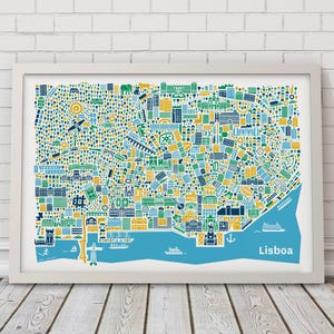 May include: A framed art print of Lisbon, Portugal, featuring a colorful, stylized map. The map uses blue, green, yellow, and white to depict buildings, landmarks, and the Tagus River. The word "Lisboa" is written in blue at the bottom right.