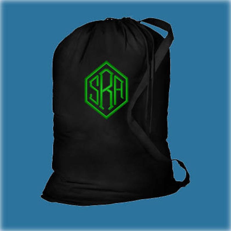A black canvas or cotton laundry bag with a kelly green embroidered monogram that reads 'SRA' in the middle of a pentagon frame using the 3 Letter Point design.
