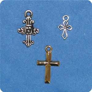May include: Three metal cross charms in different designs. One is ornate and silver, another is a simple openwork silver cross, and the third is a gold-colored cross with a classic shape. All have loops for attaching to jewelry.