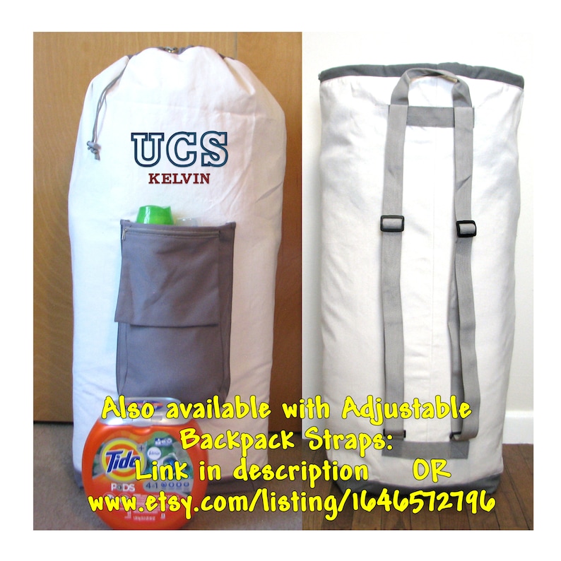 An extra large, heavy duty white laundry bag with gray trim and gray zippered pocket containing laundry detergent is in front of a closet. The back of the bag has adjustable backpack straps and carrying handle.  Varsity Initials are in navy and red thread.