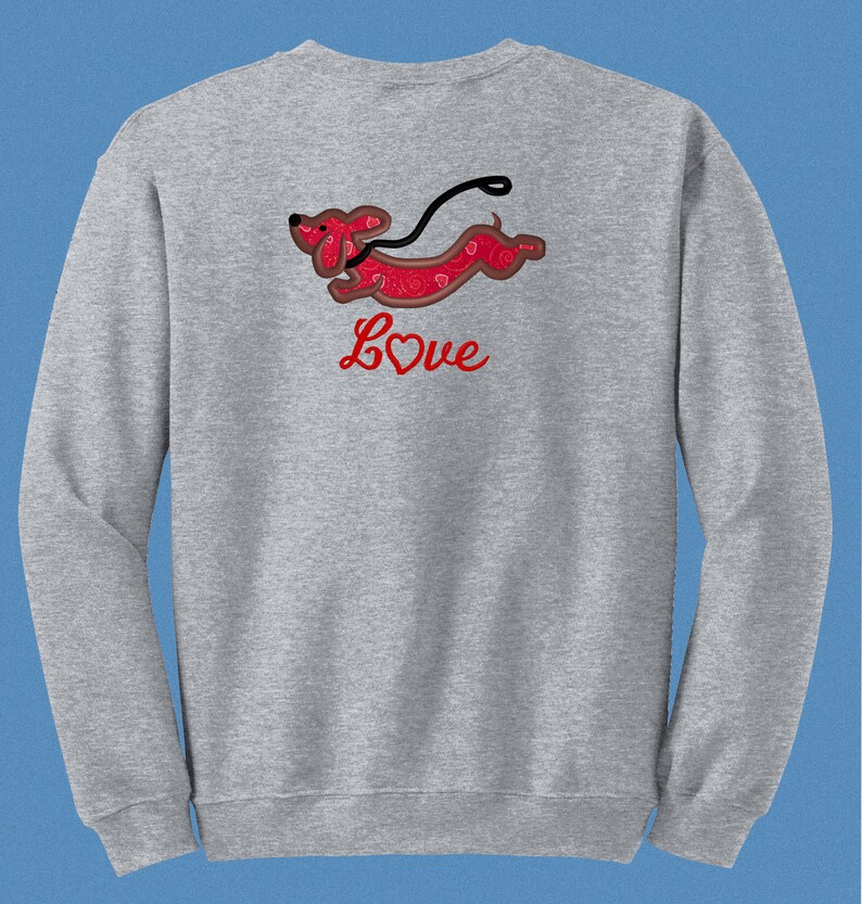 May include: Gray sweatshirt with a red dachshund running with a leash and the word "Love" with a red heart in the center.