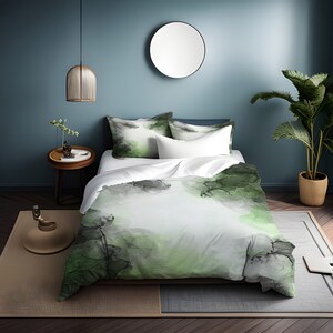 May include: A green and gray abstract print duvet cover with a white background. The duvet cover is on a bed with two pillows. The bed is in a bedroom with a blue wall and a round mirror.