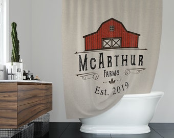 May include: A shower curtain with a vintage-style logo featuring a red barn with white windows and the text "McArthur Farms Est. 2019".