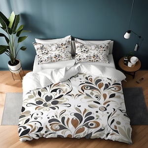 May include: A white duvet cover with a brown, gray, and black floral pattern. The duvet cover is on a bed with two matching pillowcases.
