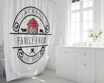 May include: White shower curtain with a black and white logo that says "Jackson Family Farm Est. 2018". The logo features a red barn, two cows, and a stylized axe.