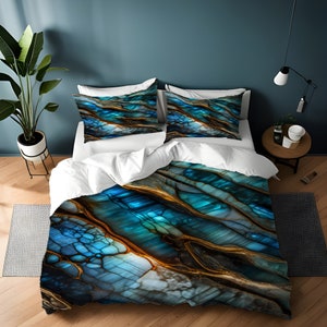 May include: A duvet cover with a blue and gold abstract pattern resembling a gemstone. The pattern features swirling lines and a textured surface.