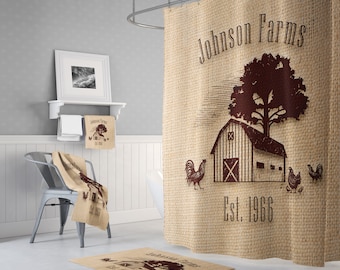 May include: A brown burlap shower curtain with a farmhouse theme. The curtain features a brown barn with a red roof, a brown tree, and the text "Johnson Farms Est. 1966".