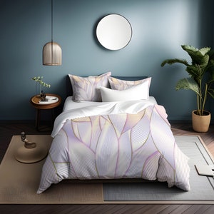 May include: White duvet cover with a purple and gold abstract floral pattern. The duvet cover is on a bed with two white pillows and a blue wall in the background.