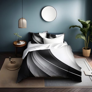 May include: A white duvet cover with a black and gray abstract design. The duvet cover is on a bed with two matching pillowcases.