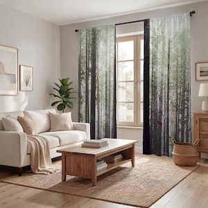 a cozy living room with a white sofa, a wooden coffee table, and a large window with curtains featuring a forest scene. The room has a neutral color palette and a warm, inviting atmosphere.