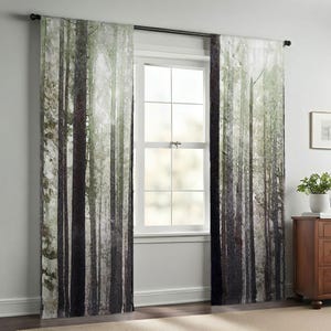 a room with a large window, featuring curtains with a forest scene printed on them. The curtains are drawn, and the window is open, allowing natural light to enter the room. There is a wooden dresser and a potted plant in the room, adding to the overall decor.