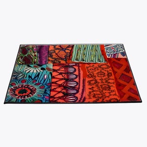 May include: A colorful patchwork rug with a variety of patterns and colors, including red, orange, green, blue, and purple.