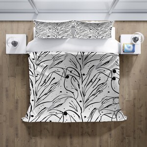 May include: Black and white bedding set featuring an abstract pattern of lines and dots. The set includes a duvet cover and two pillowcases.