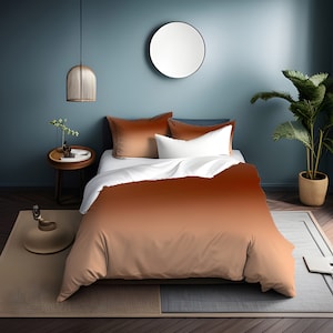 May include: A brown ombre duvet cover with a white sheet and two brown pillowcases on a bed in a room with a blue wall and a round mirror.