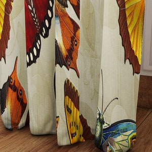 May include: A beige curtain with a repeating pattern of colorful butterflies. The butterflies have brown, yellow, orange, red, and blue wings.