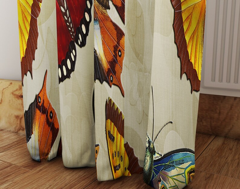 May include: A beige curtain with a repeating pattern of colorful butterflies. The butterflies have brown, yellow, orange, red, and blue wings.