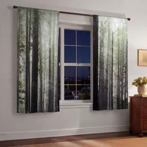 a window with a view of a forest, and the curtains are drawn to the left side of the window.