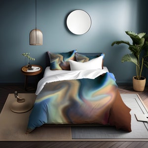 May include: A bed with a blue, brown, and green abstract swirl patterned duvet cover and two matching pillowcases. The bed is made with white sheets and a white pillow. The bed is in a room with a blue wall, a round mirror, a plant, and a side table.