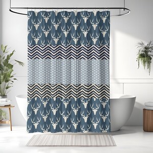 May include: A blue shower curtain with a repeating pattern of white deer heads and geometric shapes in shades of blue, black, and white.