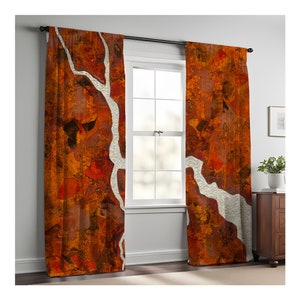 May include: A pair of orange and white patterned curtains with a white tree branch design. The curtains are hung on a black curtain rod.