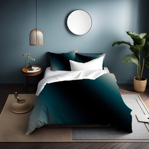 May include: A teal and green ombre duvet cover with a white pillow on a bed in a bedroom with a teal wall and a round mirror.